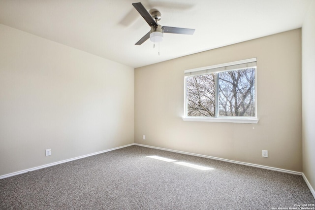 spare room with baseboards, ceiling fan, and carpet flooring