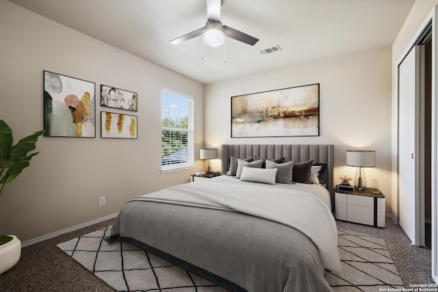 bedroom with visible vents, ceiling fan, baseboards, light carpet, and a closet