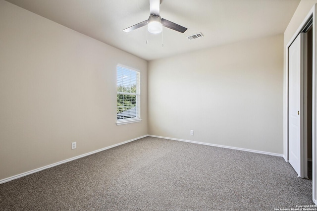 unfurnished bedroom featuring a ceiling fan, carpet, visible vents, baseboards, and a closet