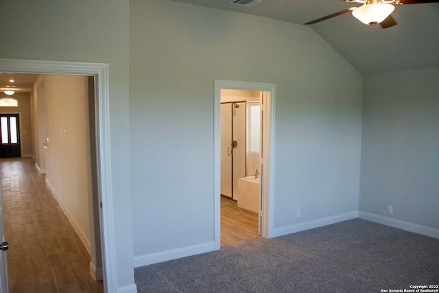 unfurnished bedroom featuring visible vents, lofted ceiling, baseboards, and carpet flooring