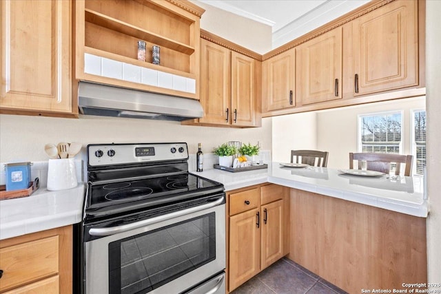 kitchen featuring extractor fan, dark tile patterned floors, light brown cabinets, and stainless steel range with electric cooktop