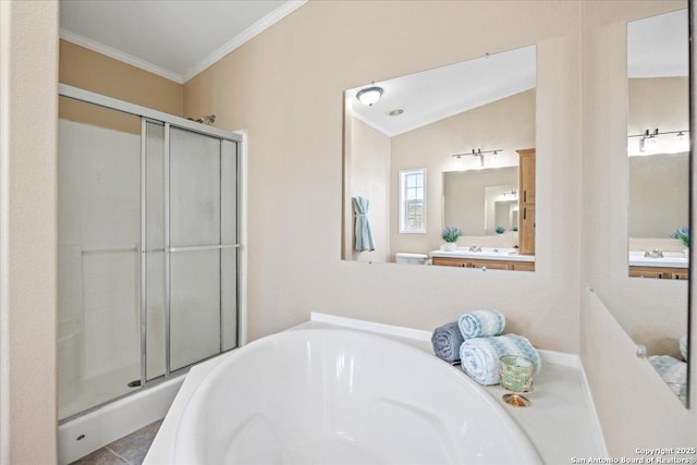 bathroom with a sink, a shower stall, a garden tub, and ornamental molding