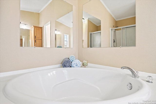 bathroom with a bath, a stall shower, and ornamental molding