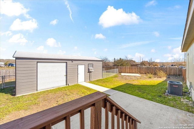 view of yard with cooling unit, an outbuilding, and a fenced backyard