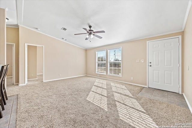 unfurnished living room with visible vents, carpet floors, crown molding, baseboards, and ceiling fan