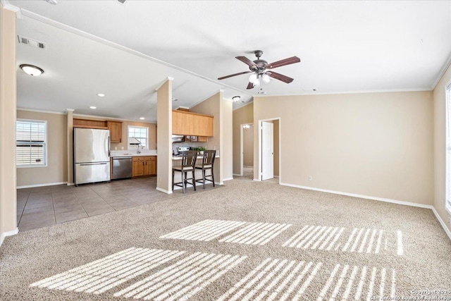 unfurnished living room featuring visible vents, light colored carpet, baseboards, and vaulted ceiling