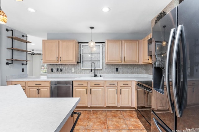 kitchen with light brown cabinetry, appliances with stainless steel finishes, light countertops, and a sink