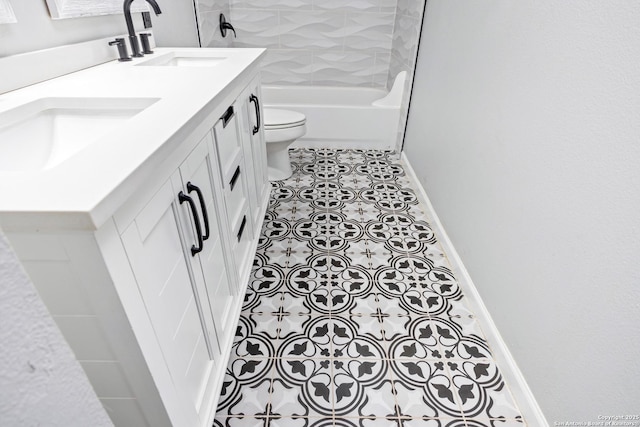 full bathroom with tile patterned floors, toilet, baseboards, and a sink