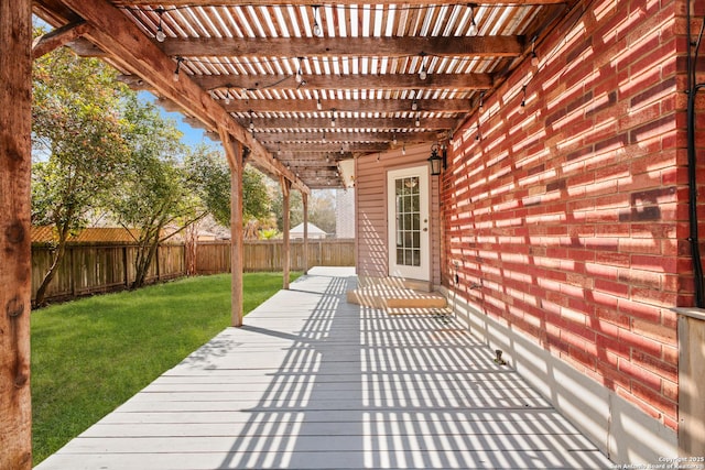 deck with a yard, a fenced backyard, and a pergola