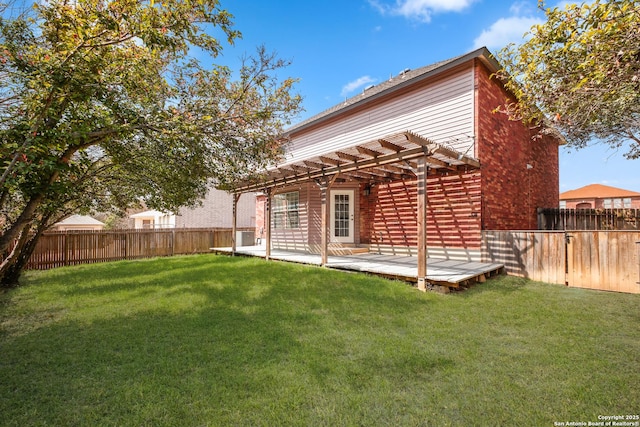 back of property featuring a yard, a wooden deck, a fenced backyard, and a pergola