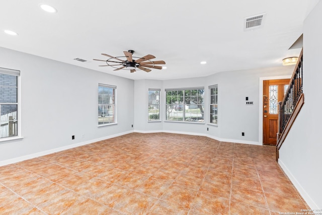 unfurnished living room with recessed lighting, visible vents, baseboards, and stairs