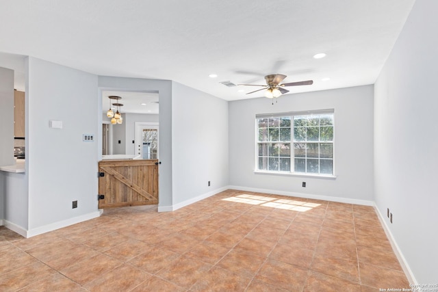 empty room with light tile patterned floors, recessed lighting, a ceiling fan, and baseboards