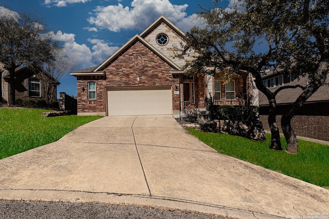 view of front of house featuring a front yard, brick siding, concrete driveway, and an attached garage