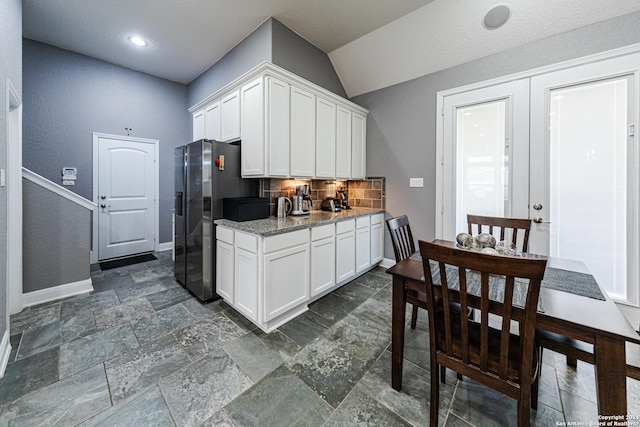 kitchen with baseboards, stainless steel fridge with ice dispenser, decorative backsplash, white cabinets, and french doors