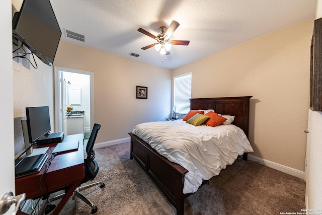 carpeted bedroom with visible vents, a textured ceiling, baseboards, and a ceiling fan