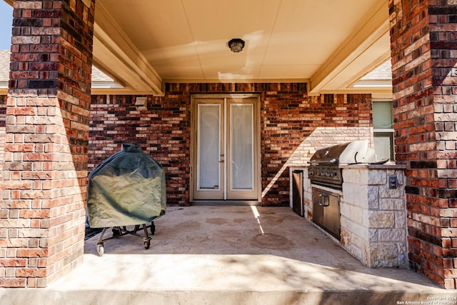 doorway to property featuring area for grilling and a patio area