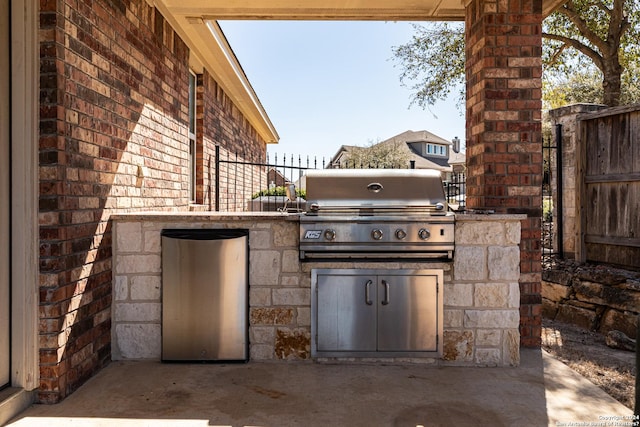 view of patio featuring area for grilling and fence