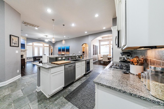 kitchen with visible vents, beverage cooler, open floor plan, appliances with stainless steel finishes, and a sink