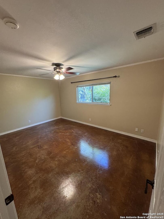 unfurnished room with ceiling fan, finished concrete flooring, visible vents, and baseboards