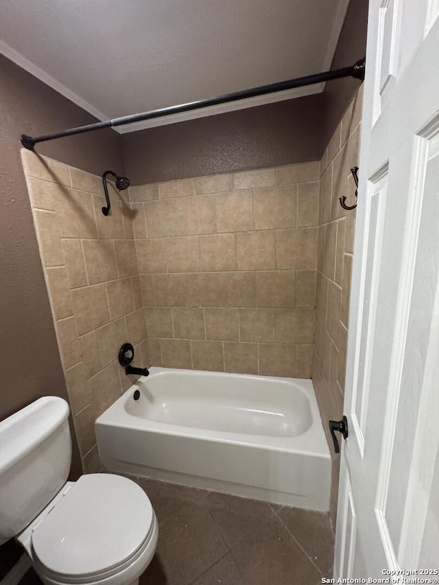 bathroom with tile patterned floors, shower / washtub combination, and toilet