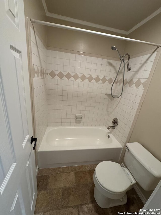 full bathroom with stone finish flooring, toilet, bathing tub / shower combination, and crown molding