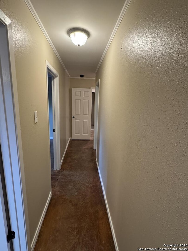 corridor with baseboards and ornamental molding