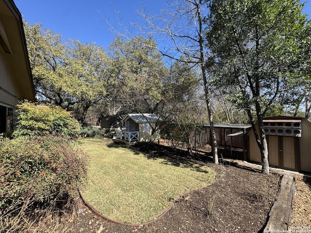 view of yard with an outbuilding and a shed