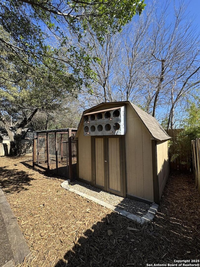 view of shed with fence