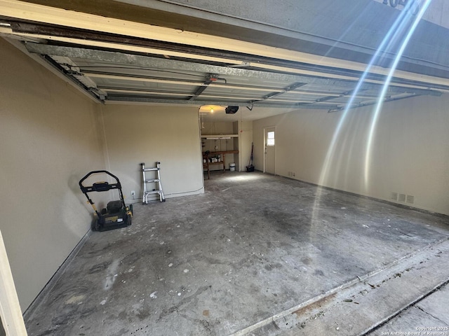 garage featuring visible vents and a garage door opener