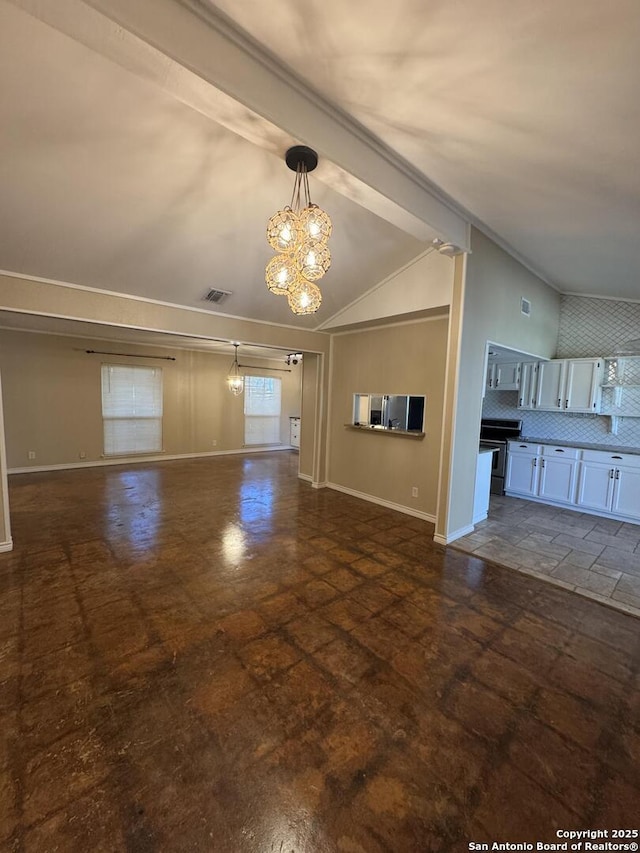 unfurnished living room with visible vents, baseboards, lofted ceiling, stone finish floor, and a notable chandelier