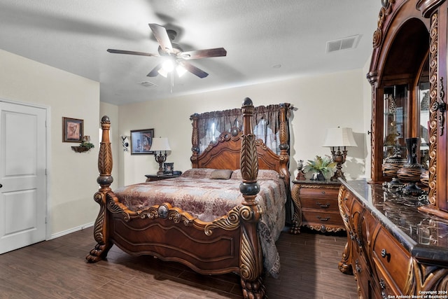 bedroom featuring visible vents, a textured ceiling, dark wood-type flooring, and ceiling fan