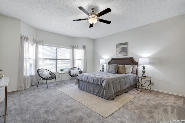 carpeted bedroom with ceiling fan, baseboards, and a textured ceiling