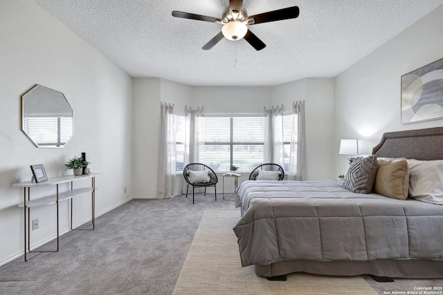 bedroom featuring baseboards, carpet, a ceiling fan, and a textured ceiling