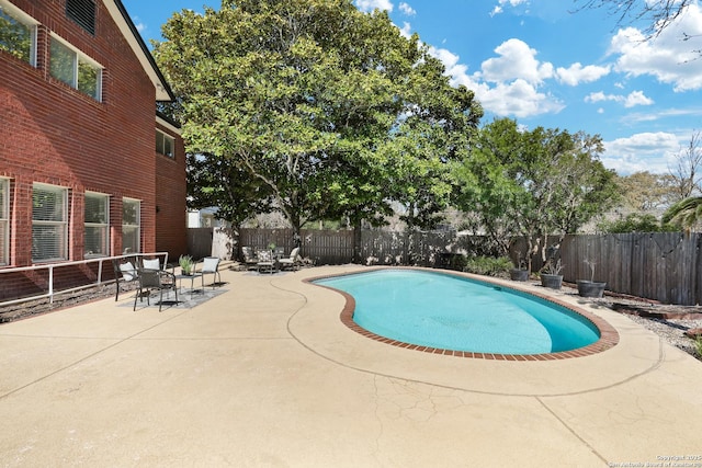 view of pool featuring a patio area, a fenced in pool, and a fenced backyard