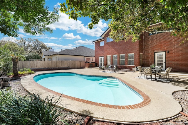 view of swimming pool featuring a patio area, a fenced in pool, and a fenced backyard