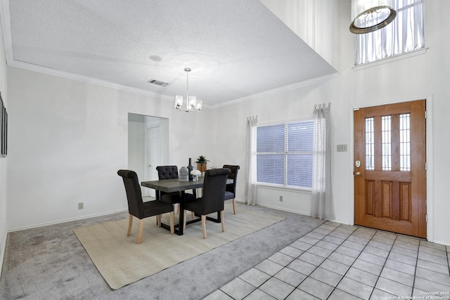 dining area featuring an inviting chandelier, crown molding, visible vents, and light carpet