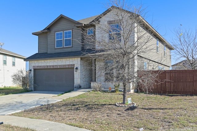 view of front of home with concrete driveway, an attached garage, fence, and stone siding