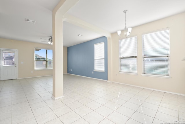 unfurnished room with light tile patterned floors, ceiling fan with notable chandelier, visible vents, and baseboards