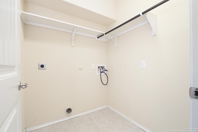 clothes washing area featuring electric dryer hookup, baseboards, gas dryer hookup, hookup for a washing machine, and laundry area