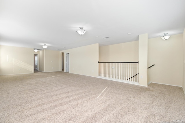 empty room featuring light colored carpet and visible vents