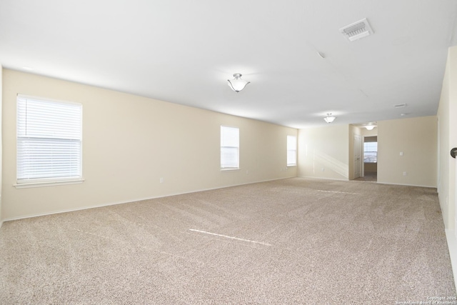 empty room featuring carpet flooring and visible vents