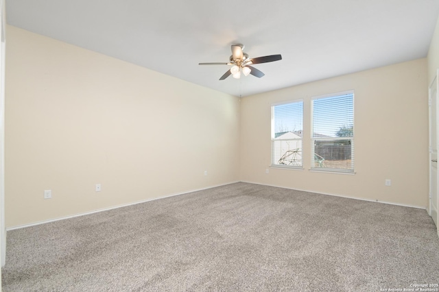 carpeted empty room featuring a ceiling fan