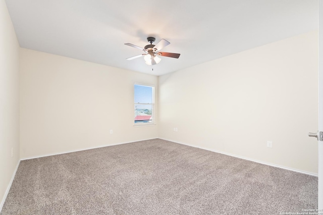 carpeted empty room with baseboards and a ceiling fan