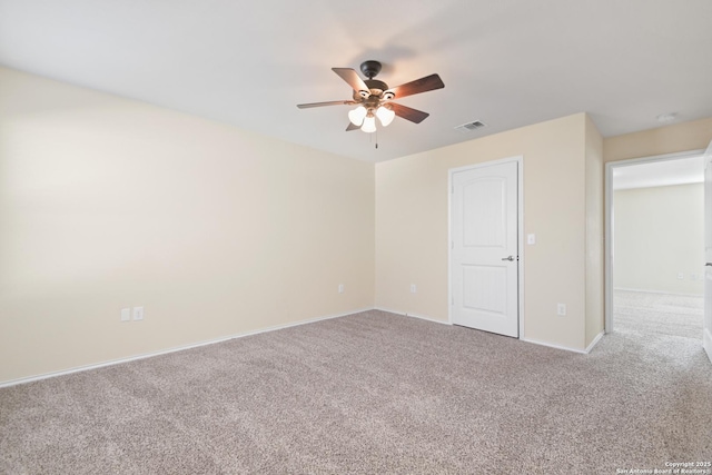 unfurnished room featuring visible vents, ceiling fan, baseboards, and carpet