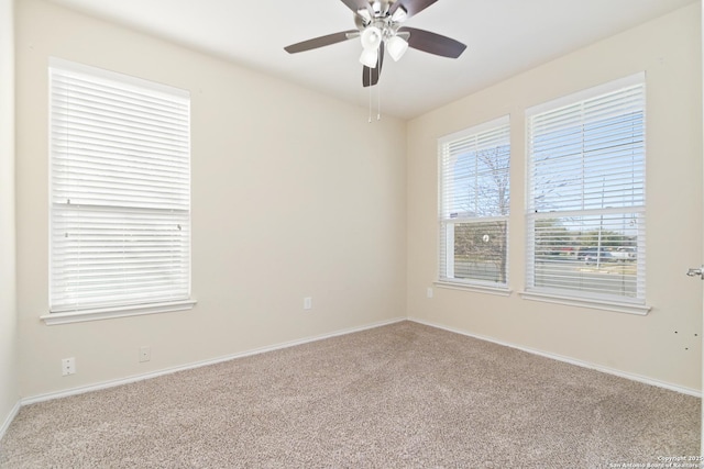 unfurnished room with a ceiling fan, baseboards, and carpet floors