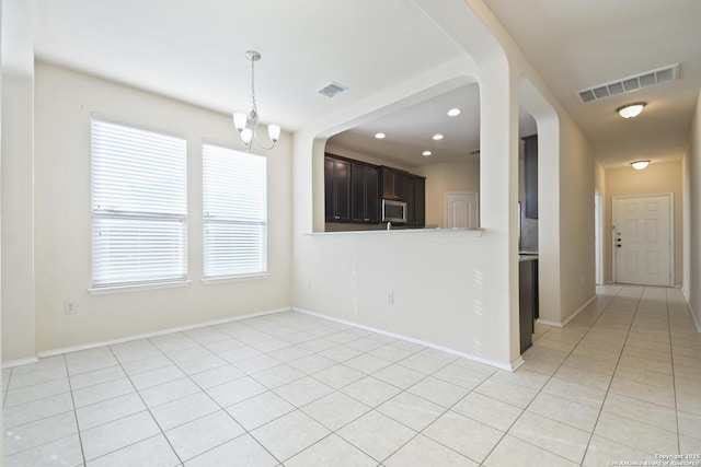 spare room with visible vents, baseboards, recessed lighting, light tile patterned flooring, and a notable chandelier