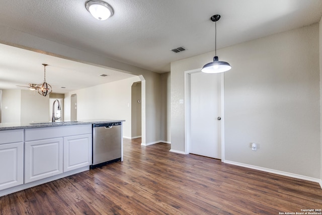 kitchen featuring a sink, dishwasher, arched walkways, white cabinetry, and dark wood-style flooring