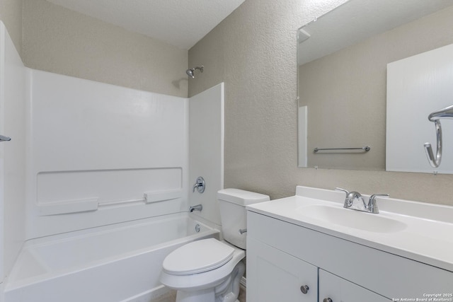 bathroom with toilet, vanity, bathing tub / shower combination, a textured wall, and a textured ceiling