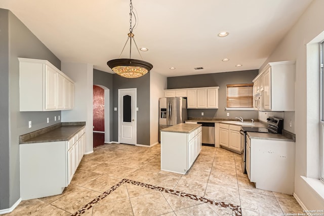 kitchen with recessed lighting, baseboards, arched walkways, and appliances with stainless steel finishes