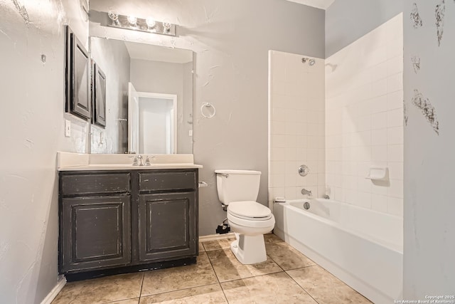 bathroom with tile patterned floors, toilet, vanity, and bathtub / shower combination